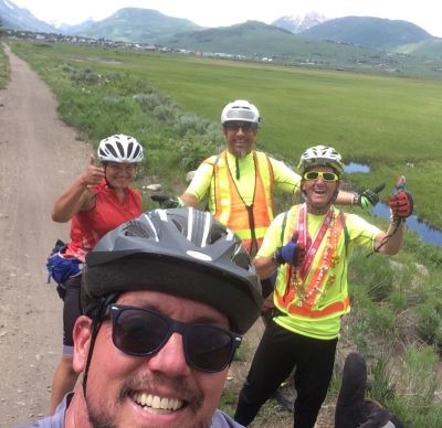 Photo of Daniel Bruce and clients on a bike ride in the mountains.