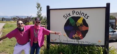 Clients in front of the Six Points Sign
